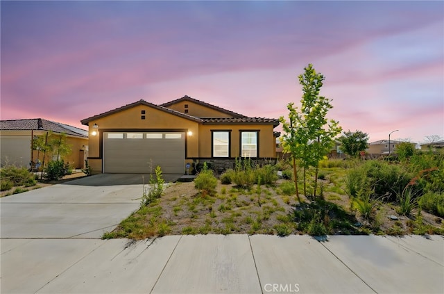 27108 Oncore Dr, Menifee, CA 92585 - mediterranean / spanish-style home with stucco siding, a garage, concrete driveway, and a tiled roof