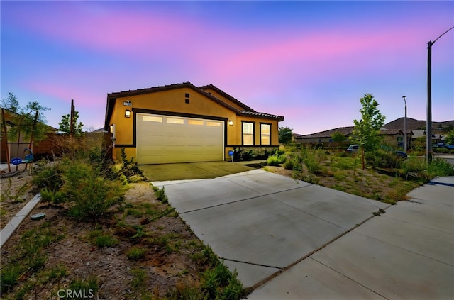 27108 Oncore Dr, Menifee, CA 92585 - view of front of home featuring a garage, driveway, stucco siding, and a tile roof