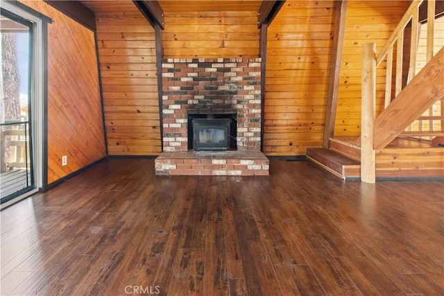 2068 Slippery Elm Rd, Wrightwood, CA 92397 - unfurnished living room featuring hardwood / wood-style flooring, wooden walls, beamed ceiling, and a brick fireplace