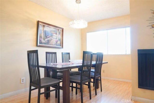 570 W Stocker St Unit 202, Glendale, CA 91202 - dining space featuring wood finished floors and a chandelier
