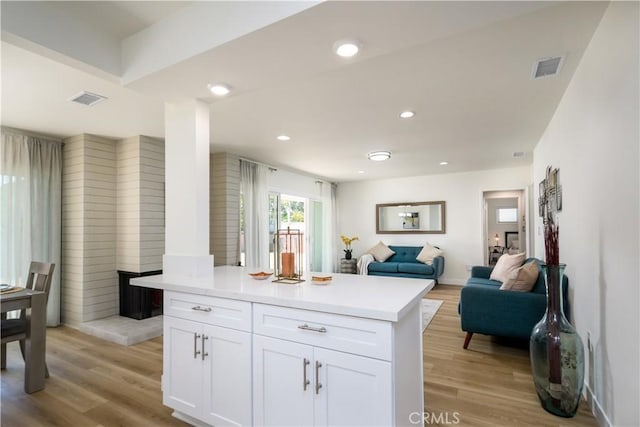 1610 Wandering Dr, Monterey Park, CA 91754 - kitchen featuring light wood-style floors, white cabinets, light countertops, open floor plan, and recessed lighting