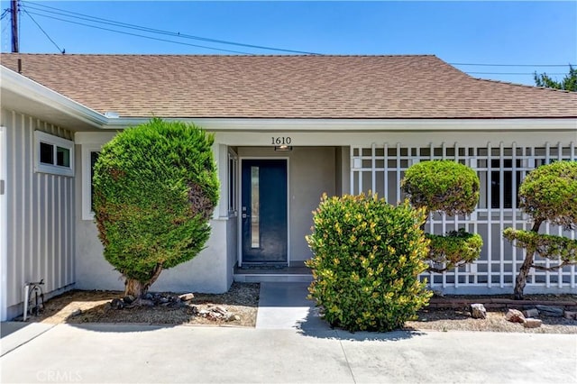 1610 Wandering Dr, Monterey Park, CA 91754 - property entrance with roof with shingles and stucco siding
