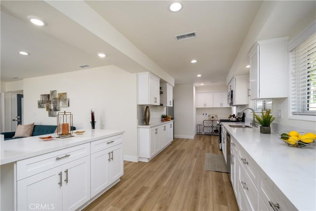 1610 Wandering Dr, Monterey Park, CA 91754 - kitchen featuring recessed lighting, white cabinets, light wood-style floors, and light countertops