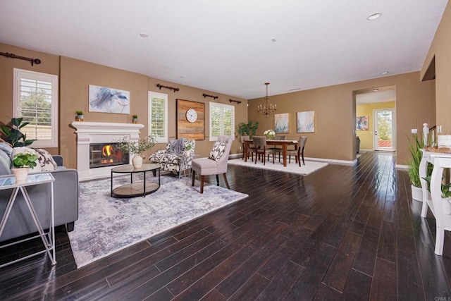 27002 Red Maple St, Murrieta, CA 92562 - living area with wood finished floors, a chandelier, a glass covered fireplace, and recessed lighting