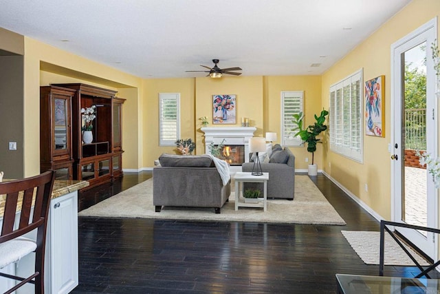 27002 Red Maple St, Murrieta, CA 92562 - living area with ceiling fan, a glass covered fireplace, and dark wood-style flooring