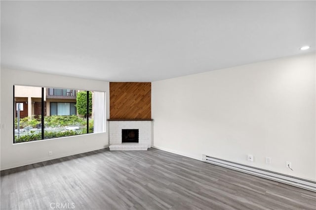 10249 Black Mountain Rd Unit Q3, San Diego, CA 92126 - unfurnished living room featuring a baseboard heating unit, wood finished floors, a brick fireplace, and recessed lighting