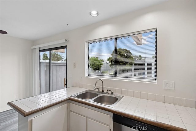 10249 Black Mountain Rd Unit Q3, San Diego, CA 92126 - kitchen with stainless steel dishwasher, tile counters, a peninsula, white cabinets, and recessed lighting