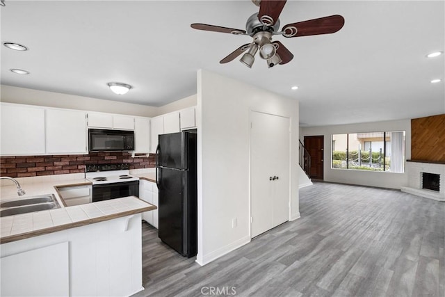 10249 Black Mountain Rd Unit Q3, San Diego, CA 92126 - kitchen featuring black appliances, tile countertops, tasteful backsplash, open floor plan, and recessed lighting