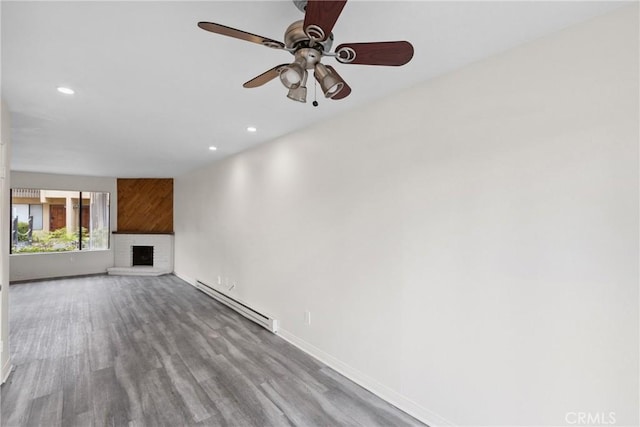 10249 Black Mountain Rd Unit Q3, San Diego, CA 92126 - unfurnished living room with a baseboard heating unit, recessed lighting, a ceiling fan, a brick fireplace, and wood finished floors