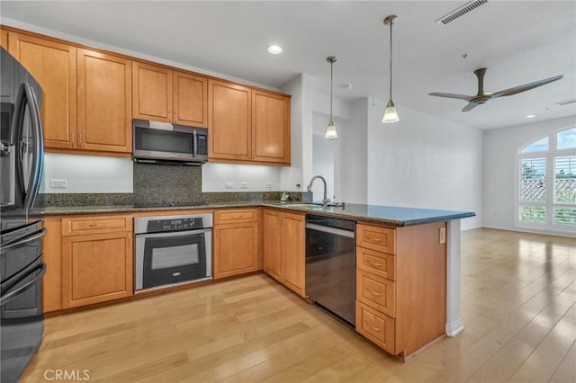 3887 Pell Pl Unit 414, San Diego, CA 92130 - kitchen featuring appliances with stainless steel finishes, light wood finished floors, a peninsula, open floor plan, and recessed lighting