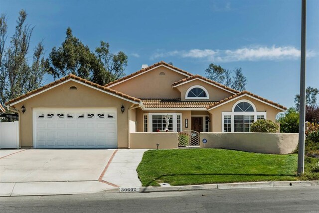30602 Colina Verde St, Temecula, CA 92592 - mediterranean / spanish home with a fenced front yard, a garage, concrete driveway, and stucco siding