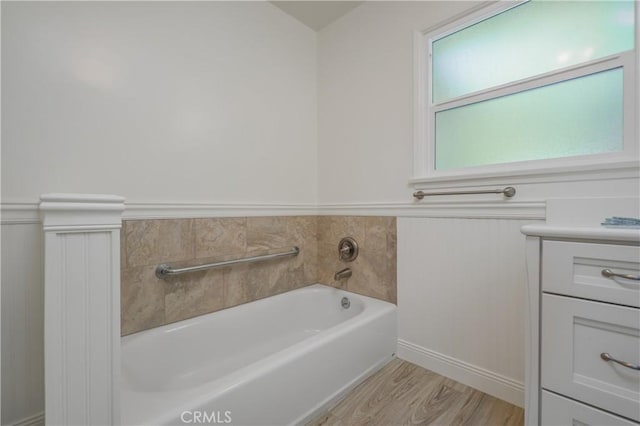 3131 E Cortez St, West Covina, CA 91791 - full bath featuring a garden tub, vanity, wood finished floors, and a wainscoted wall