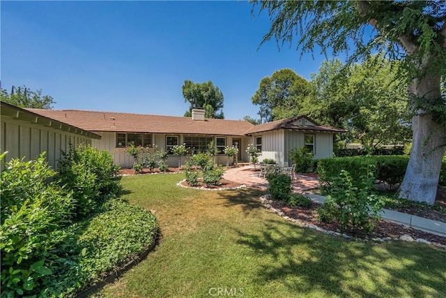 3131 E Cortez St, West Covina, CA 91791 - rear view of house featuring a lawn, a chimney, and board and batten siding