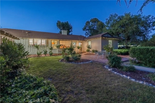 3131 E Cortez St, West Covina, CA 91791 - rear view of house with board and batten siding, a lawn, and a patio