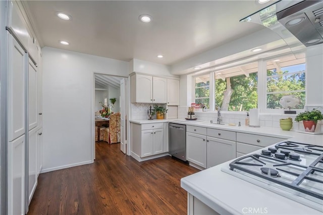 3131 E Cortez St, West Covina, CA 91791 - kitchen with stainless steel dishwasher, dark wood-type flooring, backsplash, light countertops, and white cabinetry
