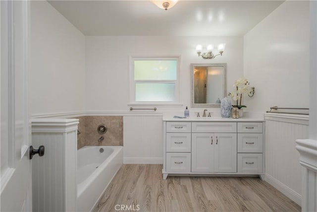 3131 E Cortez St, West Covina, CA 91791 - bathroom with a garden tub, wainscoting, vanity, and wood finished floors