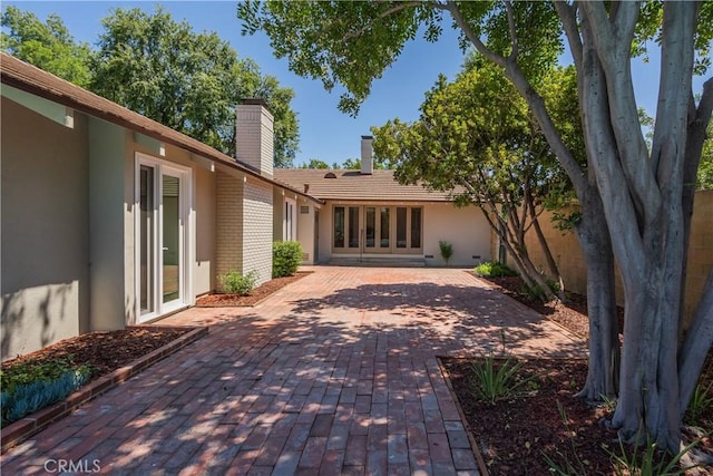 3131 E Cortez St, West Covina, CA 91791 - back of house with a chimney, a patio area, stucco siding, and brick siding