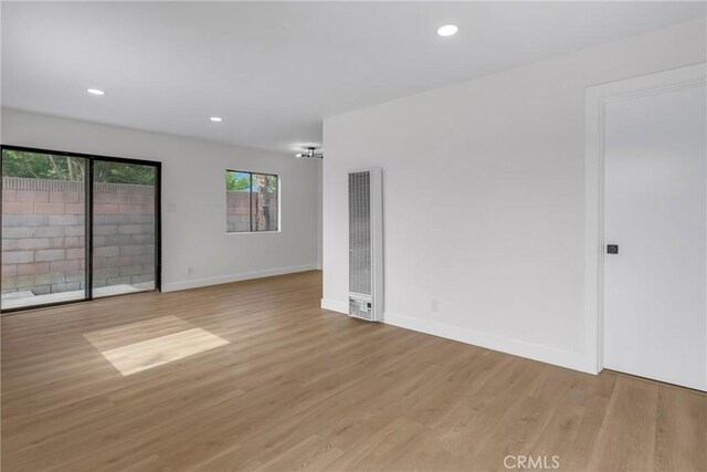 4713 Calada Ave, Pico Rivera, CA 90660 - spare room featuring a heating unit, wood finished floors, and recessed lighting