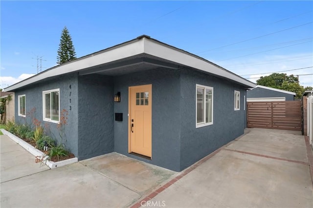 4713 Calada Ave, Pico Rivera, CA 90660 - view of front facade with stucco siding and a patio area