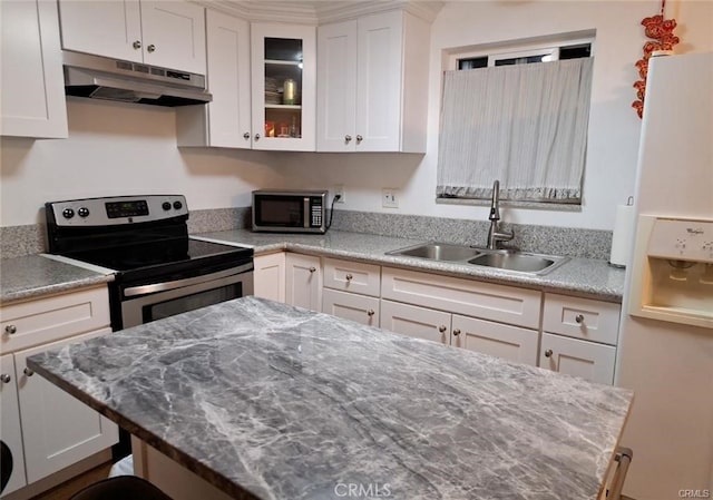 15205 S Budlong Ave Unit 9, Gardena, CA 90247 - kitchen featuring appliances with stainless steel finishes, under cabinet range hood, white cabinetry, glass insert cabinets, and light stone countertops
