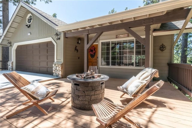 1244 St Anton Dr, Lake Arrowhead, CA 92352 - view of front of house with a fire pit, an attached garage, and a deck
