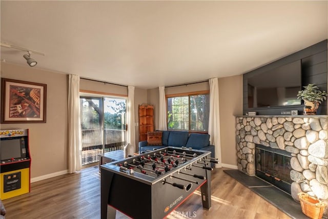 1244 St Anton Dr, Lake Arrowhead, CA 92352 - game room with wood finished floors, a fireplace, and rail lighting