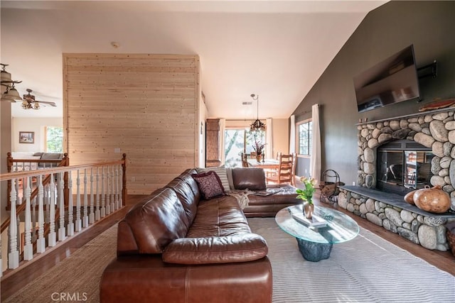 1244 St Anton Dr, Lake Arrowhead, CA 92352 - living area featuring plenty of natural light, wood finished floors, vaulted ceiling, a fireplace, and a chandelier