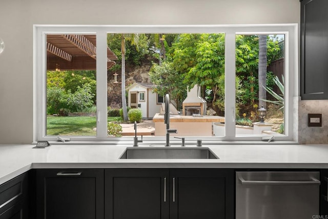 3903 Cadden Way, San Diego, CA 92117 - kitchen with stainless steel dishwasher, light countertops, dark cabinetry, and decorative backsplash