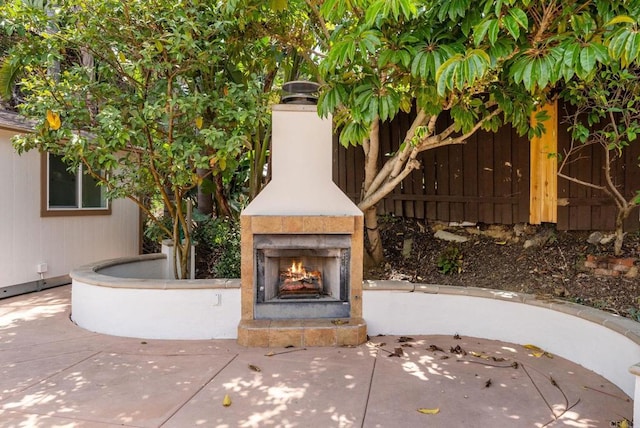 3903 Cadden Way, San Diego, CA 92117 - view of patio / terrace with a warm lit fireplace