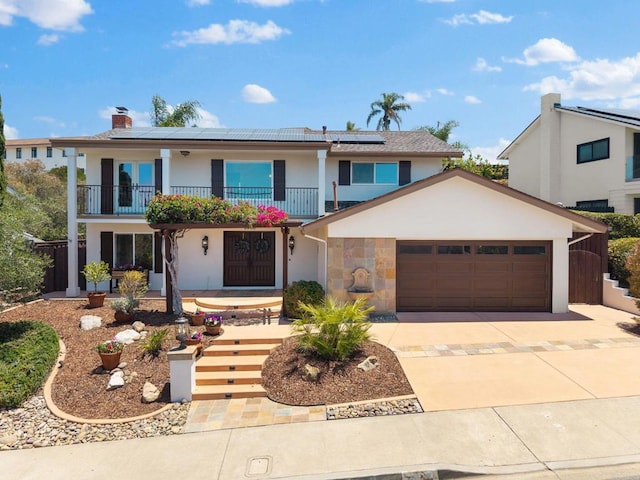 3903 Cadden Way, San Diego, CA 92117 - view of front of home with a balcony, an attached garage, solar panels, driveway, and a chimney