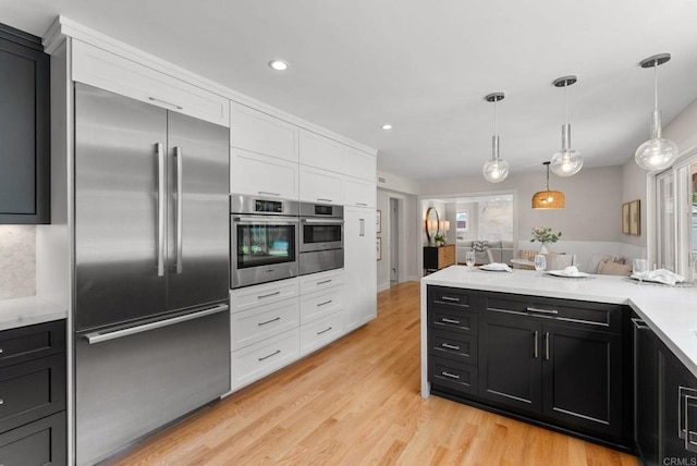 3903 Cadden Way, San Diego, CA 92117 - kitchen featuring stainless steel appliances, white cabinetry, dark cabinets, recessed lighting, and light wood-style floors