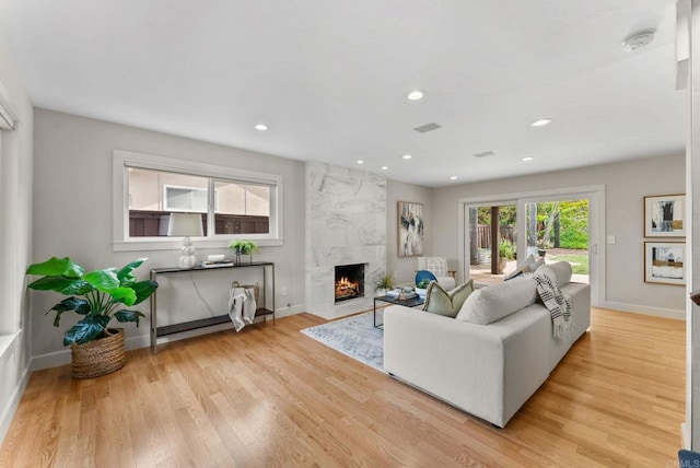 3903 Cadden Way, San Diego, CA 92117 - living area featuring a high end fireplace, light wood-style floors, and recessed lighting