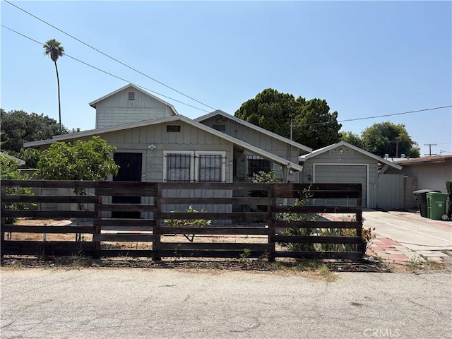 11402 Basye St, El Monte, CA 91732 - view of front of house featuring a fenced front yard, concrete driveway, and an attached garage