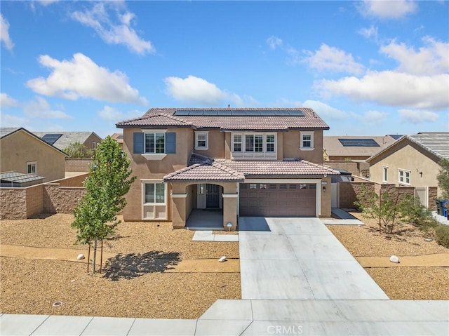 11760 Espola Pl, Victorville, CA 92392 - mediterranean / spanish home with stucco siding, a tile roof, a garage, driveway, and roof mounted solar panels
