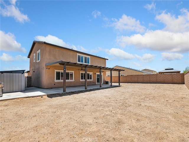 11760 Espola Pl, Victorville, CA 92392 - rear view of house with a ceiling fan, stucco siding, a patio, and a fenced backyard
