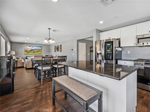 11760 Espola Pl, Victorville, CA 92392 - kitchen with appliances with stainless steel finishes, white cabinets, dark wood finished floors, recessed lighting, and a kitchen island
