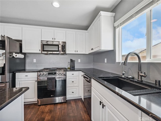 11760 Espola Pl, Victorville, CA 92392 - kitchen featuring stainless steel appliances, white cabinets, dark wood-type flooring, recessed lighting, and tasteful backsplash