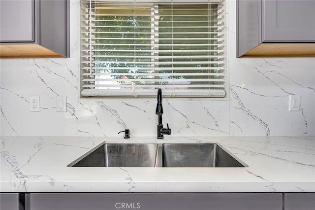 2246 Beachwood Dr, Merced, CA 95348 - kitchen view of gray cabinets, backsplash, and light stone countertops