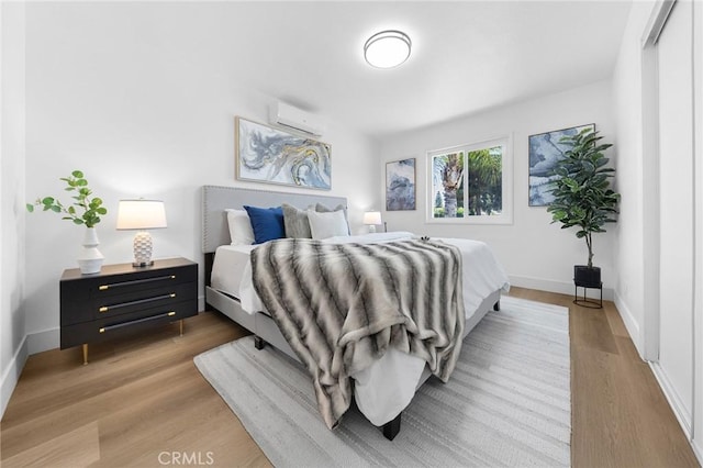 1851 S San Antonio Ave, Pomona, CA 91766 - bedroom featuring an AC wall unit and wood finished floors