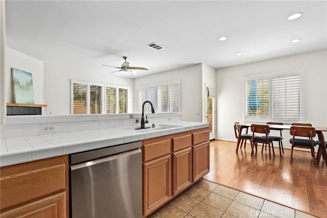27664 Cordovan Dr, Canyon Country, CA 91351 - kitchen featuring stainless steel dishwasher, plenty of natural light, light tile patterned flooring, recessed lighting, and brown cabinets