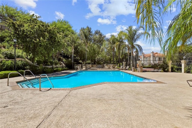 27664 Cordovan Dr, Canyon Country, CA 91351 - community pool featuring a patio and view of wooded area