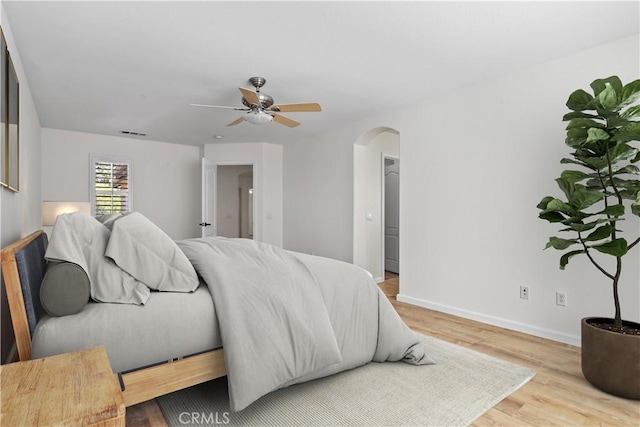 27664 Cordovan Dr, Canyon Country, CA 91351 - bedroom featuring arched walkways, wood finished floors, and a ceiling fan