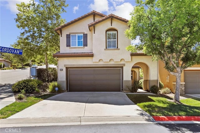 27664 Cordovan Dr, Canyon Country, CA 91351 - mediterranean / spanish-style house featuring a tiled roof, a garage, concrete driveway, and stucco siding