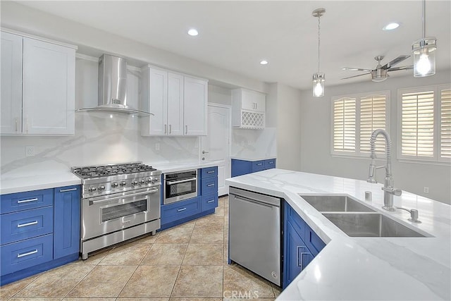 12790 Golden Leaf Dr, Rancho Cucamonga, CA 91739 - kitchen with appliances with stainless steel finishes, wall chimney range hood, blue cabinetry, white cabinetry, and recessed lighting