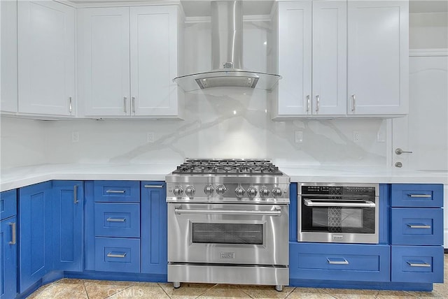 12790 Golden Leaf Dr, Rancho Cucamonga, CA 91739 - kitchen with wall chimney exhaust hood, appliances with stainless steel finishes, light countertops, blue cabinets, and white cabinets