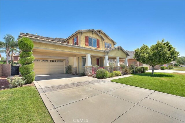 12790 Golden Leaf Dr, Rancho Cucamonga, CA 91739 - craftsman-style home with covered porch, a front yard, driveway, an attached garage, and stone siding