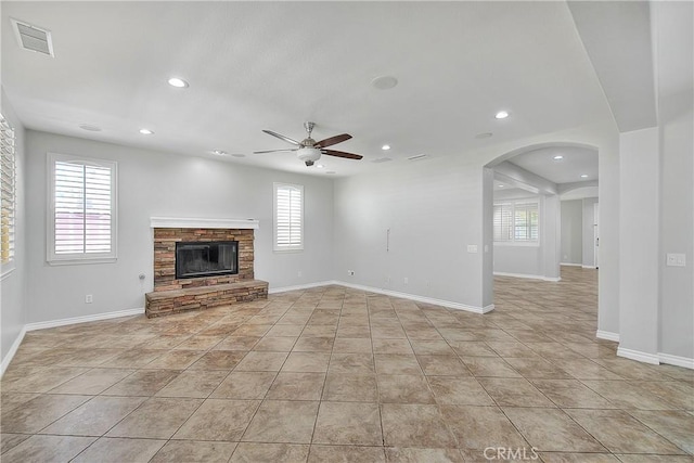 12790 Golden Leaf Dr, Rancho Cucamonga, CA 91739 - unfurnished living room featuring ceiling fan, recessed lighting, plenty of natural light, a fireplace, and arched walkways