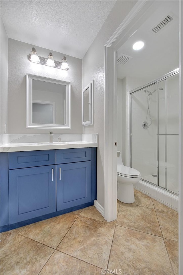 12790 Golden Leaf Dr, Rancho Cucamonga, CA 91739 - bathroom featuring vanity, a shower stall, a textured ceiling, tile patterned floors, and a textured wall