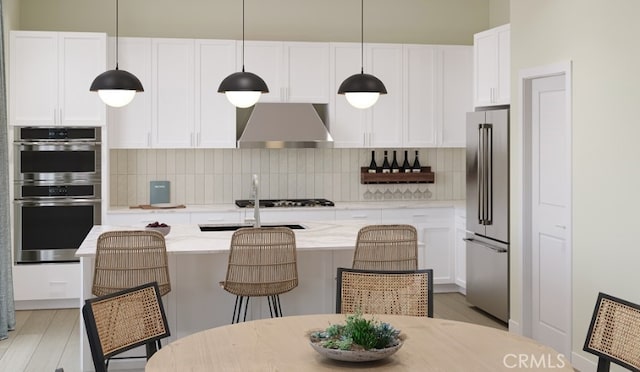 204 Lily Loop, Irvine, CA 92618 - kitchen featuring wall chimney exhaust hood, appliances with stainless steel finishes, backsplash, and white cabinets