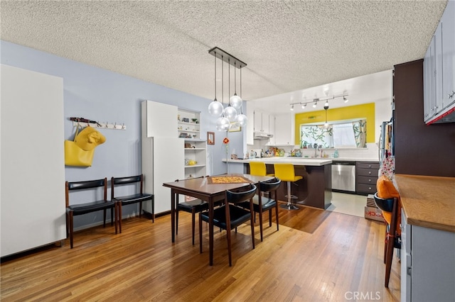 5110 E Atherton St Unit 57, Long Beach, CA 90815 - dining room featuring light wood-style floors, a textured ceiling, and track lighting